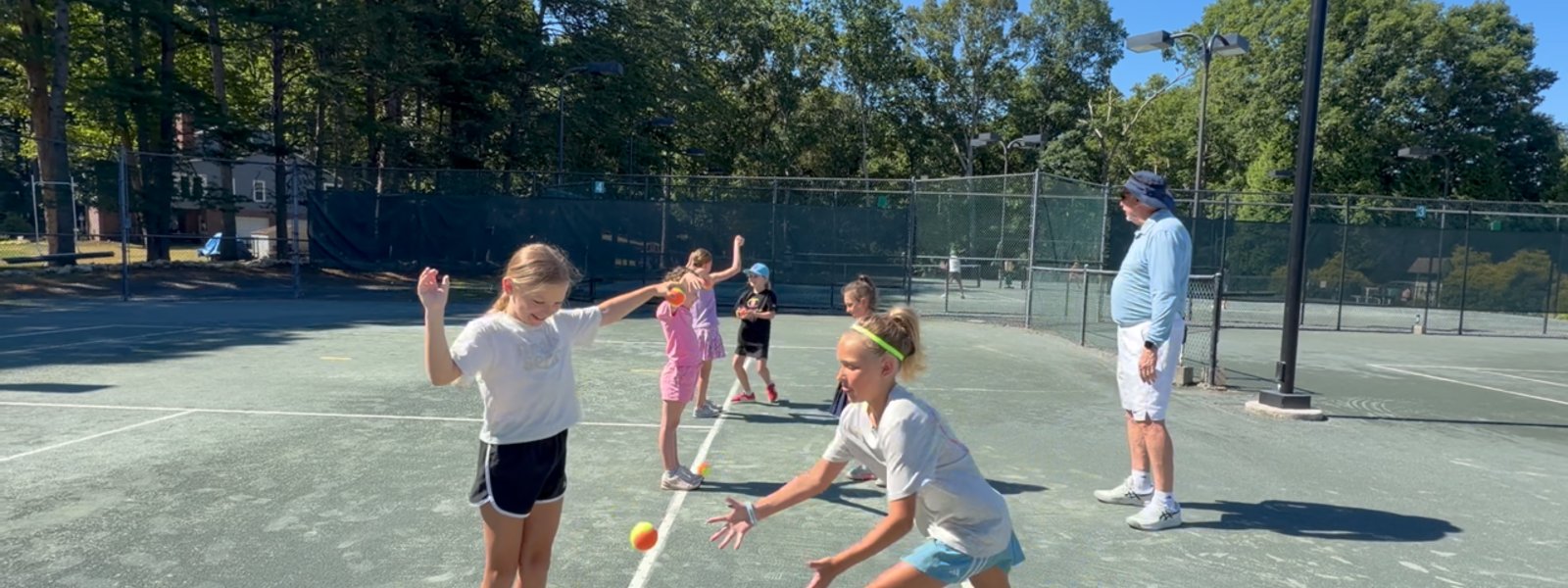 Young players practicing footwork during a junior clinic