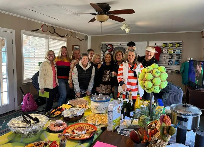 Members gathered for a social event with food and tennis-themed decorations at Asheboro Racquet & Swim Club
