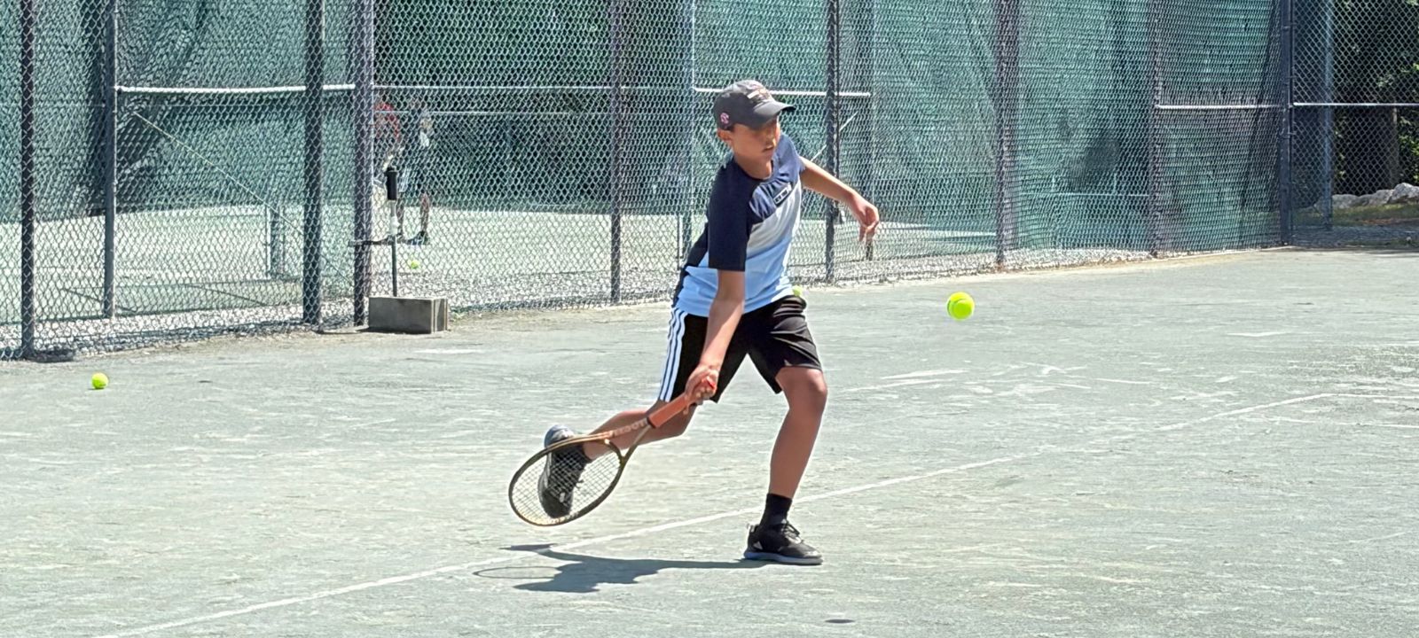 high performance junior tennis player and member hitting forehand